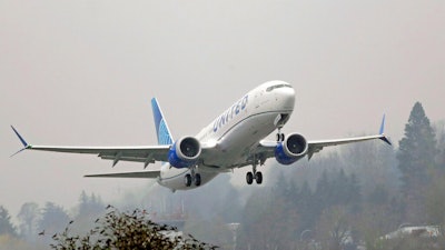 A United Airlines Boeing 737 Max airplane takes off in the rain at Renton Municipal Airport in Renton, Wash.