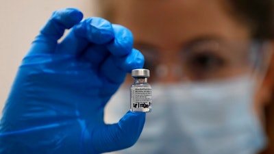 A nurse holds a phial of the Pfizer-BioNTech COVID-19 vaccine at Guy's Hospital in London.