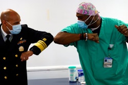 Surgeon General of the U.S. Jerome Adams, left, elbow-bumps Emergency Room technician Demetrius Mcalister.