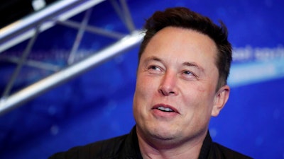 Tesla CEO Elon Musk arrives on the red carpet for the Axel Springer media award.