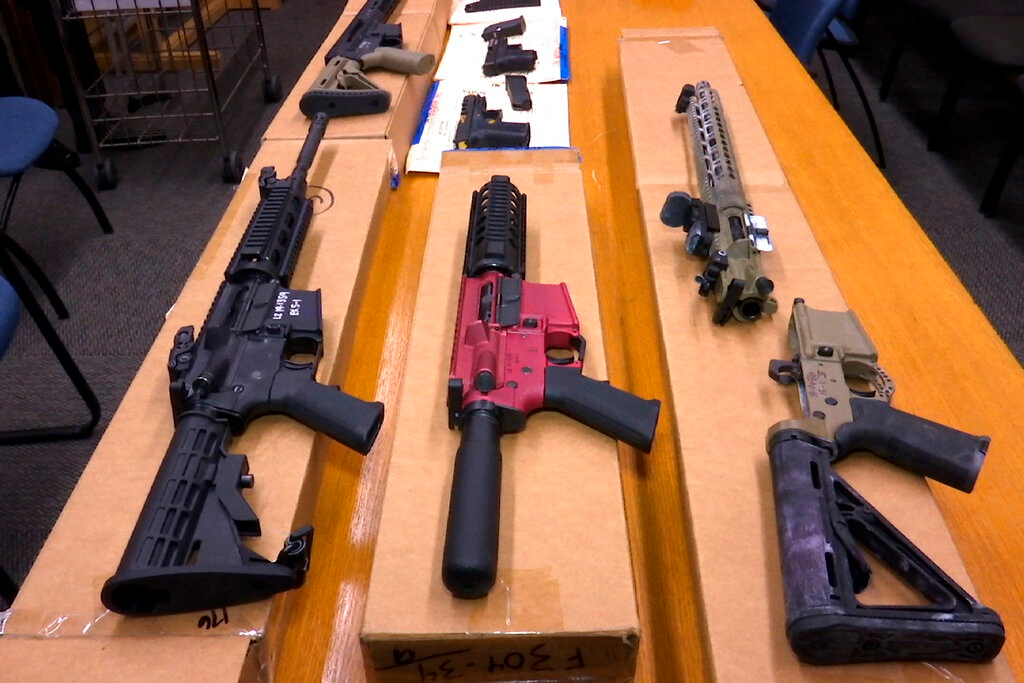 This Nov. 27, 2019, file photo shows 'ghost guns' on display at the headquarters of the San Francisco Police Department in San Francisco. Families of those killed and wounded in a rural California shooting rampage in 2017 are suing manufacturers and sellers of 'ghost gun' kits that provide easy-to-assemble firearm parts that make it difficult to track or regulate owners.