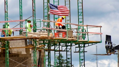 In this June 11, 2020 file photo, workers on scaffolding lay blocks on one of the larger buildings at a development site where various residential units and commercial sites are under construction in Cranberry Township, Butler County, Pa. U.S. productivity increased at a solid 4.6% pace in the July-September quarter, slightly below the initial estimate, while labor costs fell at a slower pace. The Labor Department reported that the third quarter increase in productivity was below the first estimate a month ago of a 4.9% increase.