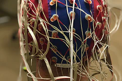 Purdue University researchers are doing work at the intersection of artificial intelligence and neuroscience. In this photo, a research participant is wearing an EEG cap with electrodes.