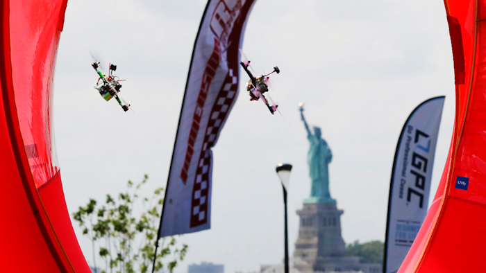 Pilots fly racing drones through an obstacle course for the National Drone Racing Championship, Governors Island, N.Y., Aug. 5, 2016.