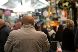 A man speaks on his mobile phone in the Mahane Yehuda market in Jerusalem, Dec. 23, 2020.