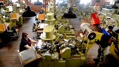 Zeida Hernandez, left, makes cigars at the J.C. Newman Cigar Co., Tampa, Fla., Dec. 14, 2020