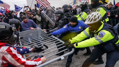 Trump supporters try to break through a police barrier on Wednesday at the Capitol in Washington.