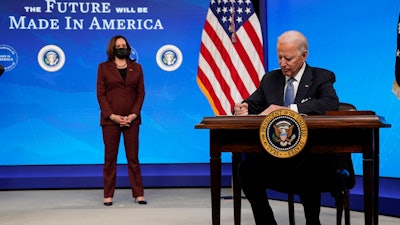 President Joe Biden signs an executive order on American manufacturing, in the South Court Auditorium on the White House complex on Monday, Jan. 25 in Washington.