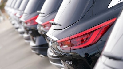 A long row of unsold 2021 QX50 sports-utility vehicles sits at an Infiniti dealership Sunday, Dec. 27, 2020, in Highlands Ranch, Colo. U.S. auto sales are expected to be down only about 15% for the year, with the average price hitting a record high as sales bounced back during the second half of the year.