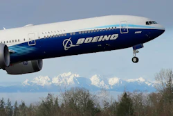 In this file photo a Boeing 777X airplane takes off on its first flight. Boeing is reporting another huge loss, this one because of a setback to its 777X widebody jetliner.