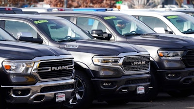 A long row of unsold 2020 pickup trucks sits at a Ram dealership Sunday, Dec. 27, 2020, in Littleton, Colo. A new government report says gas mileage for new vehicles dropped and pollution increased in model year 2019 for the first time in five years.