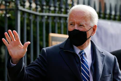 President Joe Biden waves as he departs after attending Mass at Holy Trinity Catholic Church, Sunday, Jan. 24, 2021, in the Georgetown neighborhood of Washington. Biden plans to sign an executive order Monday, Jan. 25 that aims to boost government purchases from U.S. manufacturers.