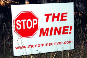 This Oct. 20, 2008 file photo shows, one of many signs that have popped up in yards, on trees and along roads in the Lake Township, Mich., section of Menominee County, where the proposed Aquila Resources Inc. mine would be located. Administrative Law Judge Daniel Pulter has overruled state regulators who granted a permit required for construction of the open-pit mine in the Upper Peninsula, in a decision released Monday. Jan. 4, 2021, creating another delay for a project that has been debated for nearly two decades.