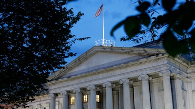 This file photo shows the U.S. Treasury Department building at dusk in Washington. The Corporate Transparency Act, enacted into law on Jan. 1, 2021, seeks to strengthen controls by creating a corporate registry managed by the Treasury Department.