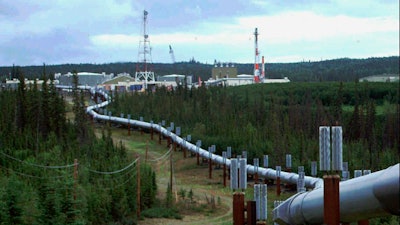 In this undated file photo the Trans-Alaska pipeline and pump station north of Fairbanks, Alaska is shown. The International Energy Agency says oil and gas companies aren't doing enough to reduce the release of methane, a potent source of planet-heating emissions, that is seeping out of pipelines and production plants.