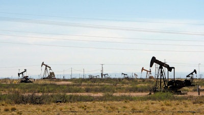 This file phot shows oil rigs in a Loco Hills field on U.S. Highway 82 in Eddy County near Artesia, N.M.