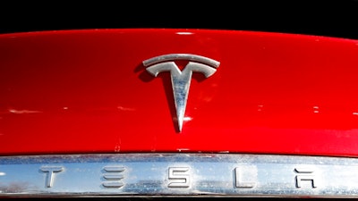 In this Feb. 2, 2020, file photo, the company logo appears on an unsold 2020 Model X at a Tesla dealership in Littleton, Colo. The U.S. government’s auto safety agency has rejected a request to investigate unintended acceleration in Tesla electric vehicles, saying the acceleration was caused by drivers pushing the wrong pedal.