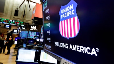 In this Sept. 13, 2019, file photo the logo for Union Pacific appears above a trading post on the floor of the New York Stock Exchange. A federal judge has blocked one of Union Pacific's main unions from going on strike over its concerns about the railroad's efforts to protect employees from the coronavirus. Judge Brian Buescher ruled Thursday, Jan. 7, 2021 that the union must address its concerns through contract talks with the railroad and it doesn't have the right to strike now.