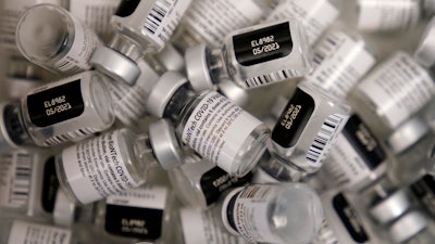 In this file photo, empty vials of the Pfizer-BioNTech COVID-19 vaccine are seen at a vaccination center at the University of Nevada, Las Vegas in Las Vegas.