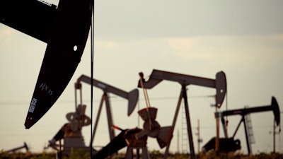 In this file photo, oil rigs stand in the Loco Hills field near Artesia, N.M.. In the closing months of the Trump administration energy companies stockpiled enough drilling permits for western public lands to keep pumping oil for years.