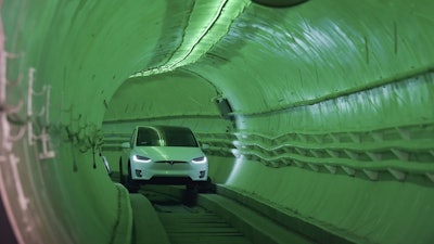 Elon Musk arrives in a modified Tesla Model X during an unveiling event for the Boring Company test tunnel, Hawthorne, Calif., Dec. 18, 2018.