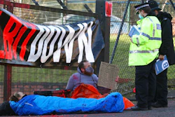 Police talk to protesters blocking the entrance to the Elbit Ferranti arms company, Oldham, England, Feb. 1, 2021.