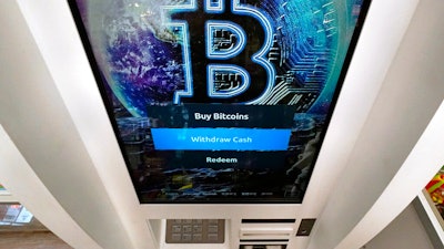 The Bitcoin logo appears on the display screen of a crypto currency ATM at the Smoker's Choice store on Feb. 9 in Salem, NH.