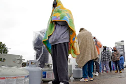 Carlos Mandez waits in line to fill propane tanks, Houston, Feb. 17, 2021.