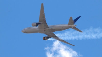 This Saturday, Feb. 20, 2021 photo provided by Hayden Smith shows United Airlines Flight 328 approaching Denver International Airport, after experiencing 'a right-engine failure' shortly after takeoff from Denver. Federal regulators are investigating what caused a catastrophic engine failure on the plane that rained debris on Denver suburbs as the aircraft made an emergency landing. Authorities said nobody aboard or on the ground was hurt despite large pieces of the engine casing that narrowly missed homes below.