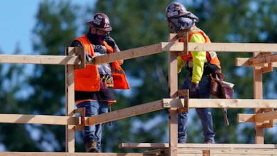 Construction workers talk at a USA Properties Fund site in Simi Valley, California. Hiring has weakened for six straight months.