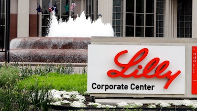 In this April 26, 2017, file photo shows the Eli Lilly and Co. corporate headquarters in Indianapolis. Eli Lilly’s new COVID-19 treatment helped the drugmaker’s fourth-quarter profit surge even though U.S. regulators approved its use late in the quarter. The antibody treatment bamlanivimab brought in $871 million in sales for Lilly after the Food and Drug Administration authorized emergency use in November 2020 for patients with mild-to-moderate COVID-19.