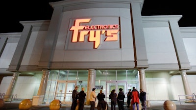 In this Oct. 21, 2009 file photo, a small crowd begins to gather outside a Fry's Electronics store in Renton, Wash. The electronics chain is permanently closing, citing the struggles it faced as a retailer during the coronavirus pandemic. The company, which was in business for 36 years, had 31 stores in nine states. Fry’s Electronics Inc. said it stopped regular operations and began the wind-down process of its business on Wednesday, Feb. 24, 2021.