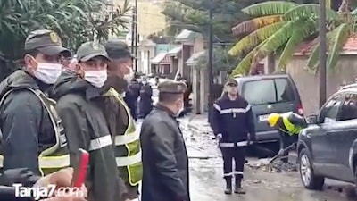 In this image made from video provided by Tanja 7, firefighters and emergency workers at the scene of flooding in Tangier, Morocco, Monday, Feb, 8 2021.