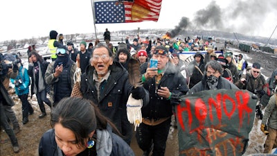 In this Feb. 22, 2017, file photo, a large crowd representing a majority of the remaining Dakota Access Pipeline protesters march out of the Oceti Sakowin camp near Cannon Ball, N.D. After President Joe Biden revoked Keystone XL's presidential permit and shut down construction of the long-disputed pipeline that was to carry oil from Canada to Texas, opponents of other pipelines hoped the projects they've been fighting would be next.