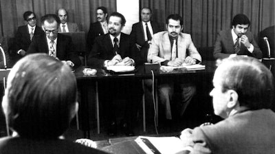 In this Oct. 8, 1973, file photo, oil ministers of six Persian Gulf countries and representatives of western nations meet in Vienna, Austria, to negotiate price boosts sought by oil producers. Facing each other, are from left to right, Dr. Jamshid Amouzegar, then Iran Finance Minister, then Saudi Oil Minister Ahmed Zaki Yanani. Yamani, a long-serving oil minister in Saudi Arabia who led the kingdom through the 1973 oil crisis, the nationalization its state energy company and later found himself kidnapped by the assassin Carlos the Jackal, died Tuesday, Feb. 23, 2021, in London. He was 90.