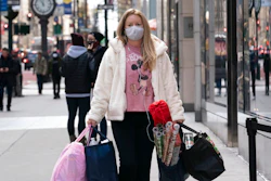 In this Dec. 10, 2020 file photo, a woman carries shopping bags in New York. The nation’s largest retail trade group is forecasting strong retail sales growth in 2021 that could surpass last year's pace as individuals get vaccinated and the economy reopens. The National Retail Federation anticipates that retail sales will grow between 6.5% and 8.2% to more than $4.33 trillion this year.