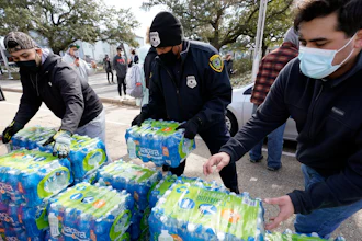 Donated water is distributed to residents, Thursday, Feb. 18, 2021, in Houston. Houston and several surrounding cities are under a boil water notice as many residents are still without running water in their homes.