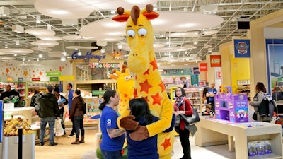 In this Dec. 9, 2019, file photo a girl hugs the Toys R Us mascot, Geoffrey, at the new store at a mall in Paramus, N.J The only two Toys R Us stores that opened in November 2019 as part of a small U.S. comeback attempt by the iconic toy chain have now closed. The Toys R Us store at the Galleria mall in Houston shuttered on Jan. 15, while one at the Garden State Plaza in Paramus, New Jersey, closed on Tuesday, Jan. 26, 2021 according Tru Kids, a new entity formed when it acquired Toys R Us’ intellectual property during its liquidation in 2018.