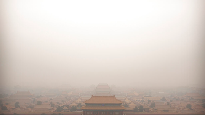 In this Jan. 18, 2020, file photo, a bird flies over the Forbidden City on a day with high levels of air pollution in Beijing. China's Premier Li Keqiang announced that the country would target a reduction of 18% in carbon intensity over the course of the next five years as part of the meeting of the ceremonial legislature which kicked off its annual meeting Friday, March 5, 2021.