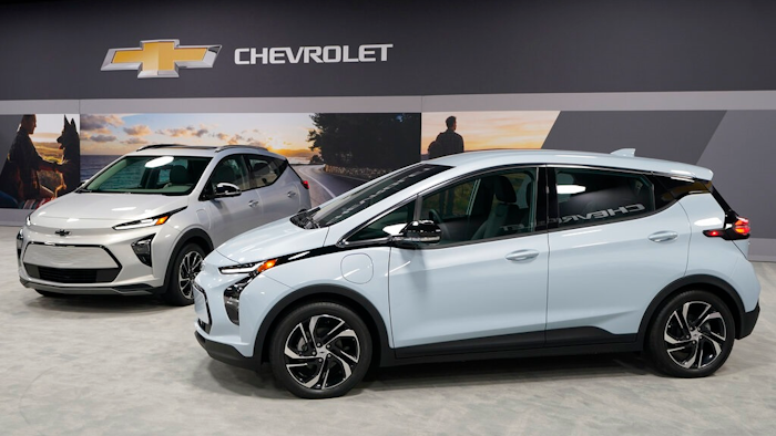 The 2022 Bolt EV, foreground, and EUV are displayed, Thursday, Feb. 11, 2021, in Milford, Mich. Whether people want them or not, automakers are rolling out multiple new electric vehicle models as the auto industry responds to stricter pollution regulations worldwide and calls to reduce emissions to fight climate change.