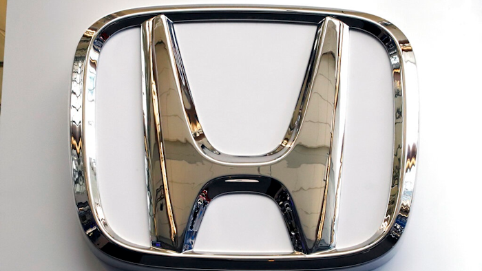 This Feb. 14, 2019 file photo shows a Honda logo at the 2019 Pittsburgh International Auto Show in Pittsburgh. Honda has plans to sell two all-electric SUVs in the U.S. for the 2024 model year, and it soon will offer hybrid gas-electric versions of its top-selling models. The announcements Thursday, March 11, 2021 come as the automaker acknowledges it has work to do to comply with emissions-reduction targets that will be coming from the Biden administration, and a California ban on sales of new internal-combustion vehicles by 2035.