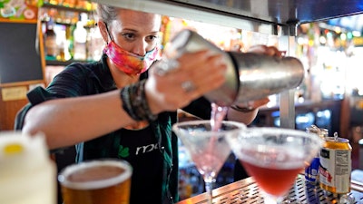 Bartender Alyssa Dooley makes a cocktail at Mo's Irish Pub on Tuesday, March 2 in Houston.