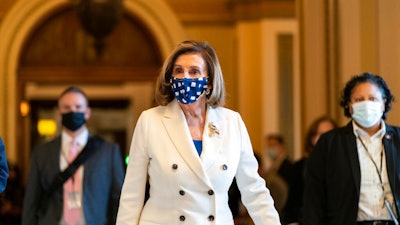 House Speaker Nancy Pelosi of Calif., walks from the House floor, during the vote on the Democrat's $1.9 trillion COVID-19 relief bill, on Capitol Hill on March 10 in Washington.