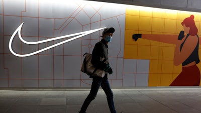 A mall visitor passes by a Nike store in Beijing on Monday, March 29, 2021.