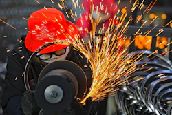 Workers wearing face masks polish bicycle wheel rims at a factory in Hangzhou in east China's Zhejiang province on Feb. 19, 2021. China's manufacturing recovery weakened for a third month in February as exports and new orders declined, according to two surveys released on Monday, March 1, 2021.