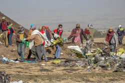 In this file photo, rescuers work at the scene of an Ethiopian Airlines flight crash near Bishoftu, or Debre Zeit, south of Addis Ababa, Ethiopia.