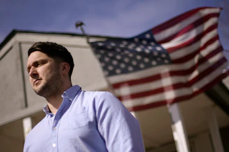 Logan DeWitt stands outside his home in Kansas City, Kansas.