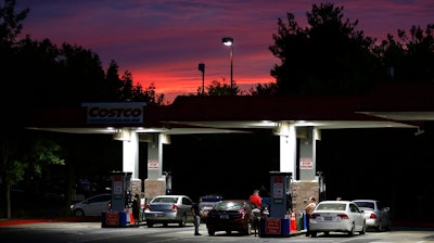 In this Wednesday, Sept. 30, 2015, photo, motorists get gas at a station in Sacramento, Calif. A Northern California city has become what's believed to be the first in the country to ban all new gas stations in an effort to curb emissions. The San Francisco Chronicle reports that the Petaluma City Council voted unanimously Monday, March 1, 2021, to prohibit the creation, expansion, reconstruction and relocation of gas stations.