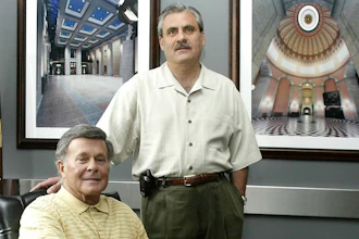 In this file photo Paul Tipps, left, and Neil Clark, pose in their office in Columbus, Ohio.