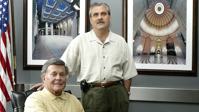 In this file photo Paul Tipps, left, and Neil Clark, pose in their office in Columbus, Ohio.